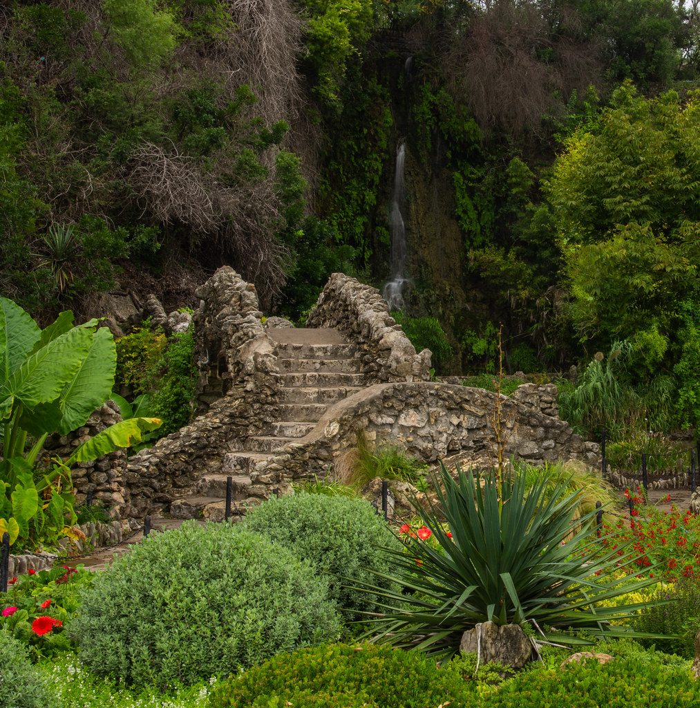 A stone path running between planted beds in a residential garden